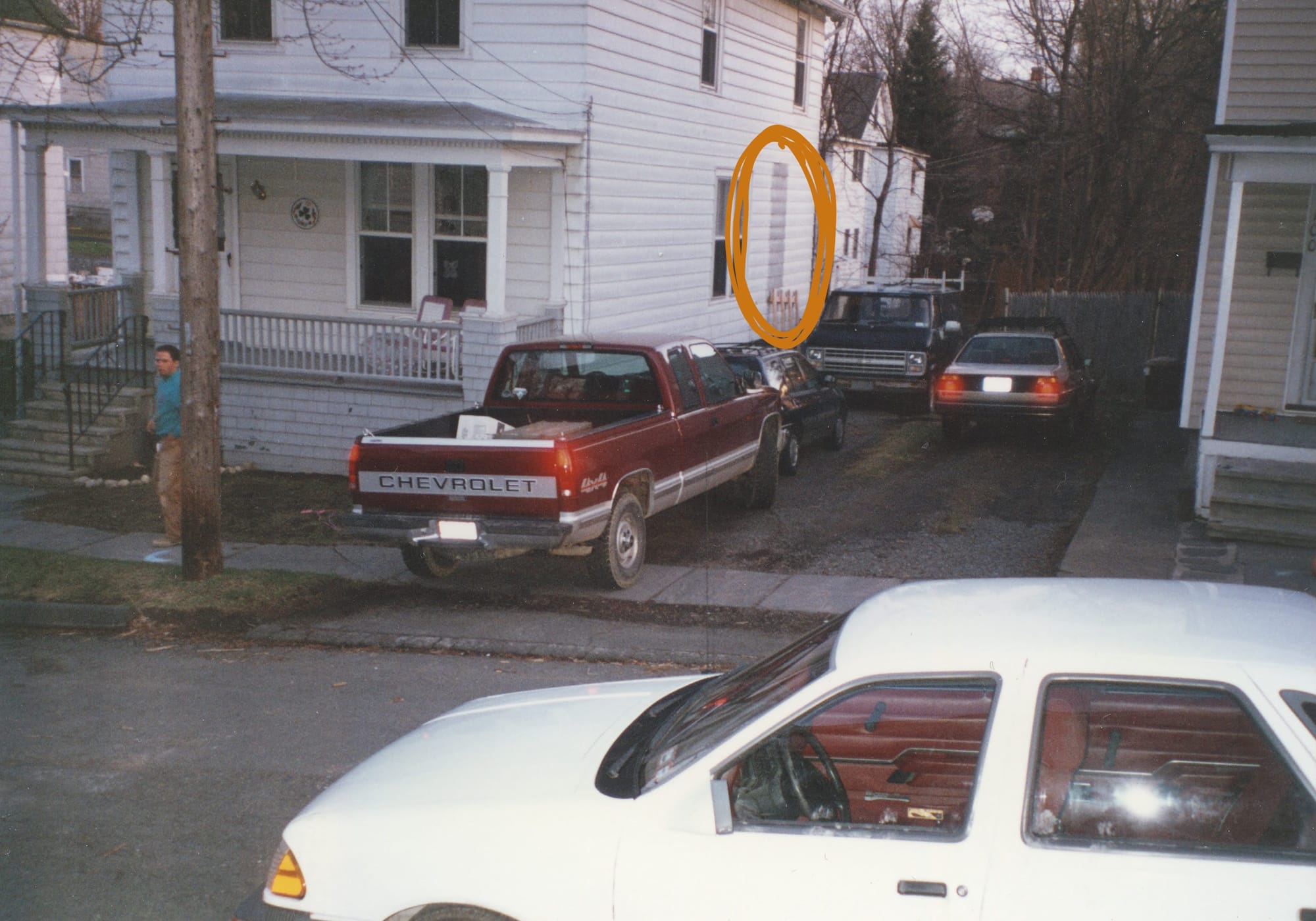 A photo of a house from across the street, with an orange circle indicating a patch in the siding.
